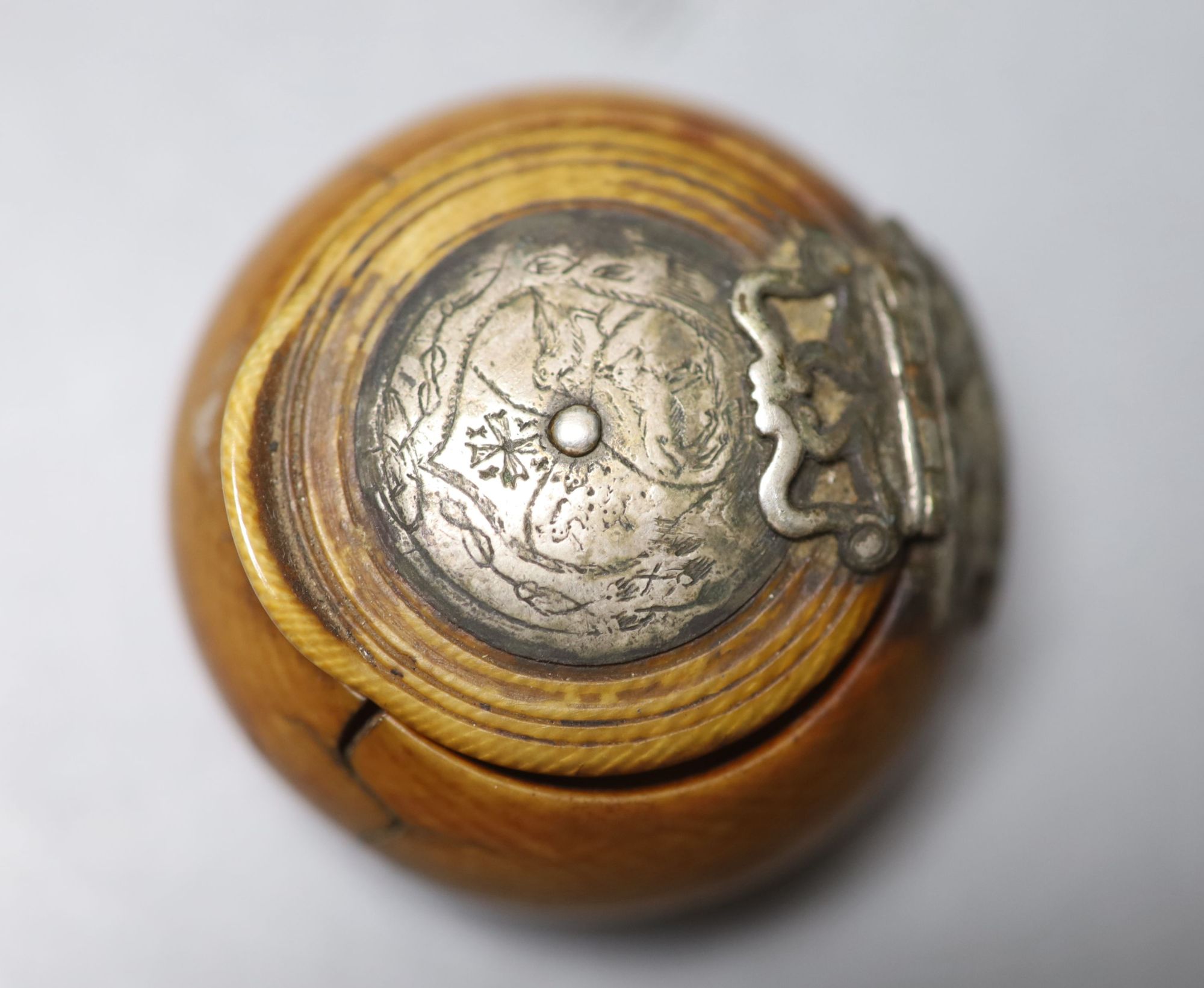 A 17th century French white metal mounted ivory snuff box, with pique work to inner lid, diameter 4.5cm